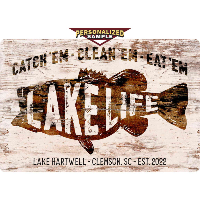 Personalized Example of Sunshine Corner's customizable, aluminum composite fish camp and lake house sign that says, "Catch'Em - Clean'Em - Eat'Em - Lake Life - Lake Hartwell - Clemson, SC - Est. 2022".