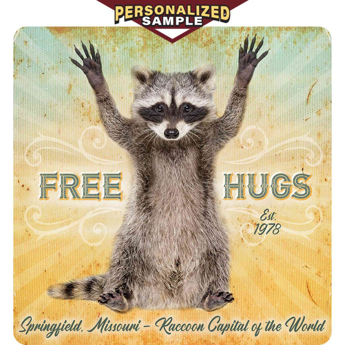 Personalized example of Sunshine Corner's customizable, raccoon decor that says, "Free Hugs - Springfield, Missouri - Raccoon Capital of the world - est. 1978".
