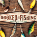 A personalized example of Sunshine Corner's aluminum composite, customizable fish camp sign that says, "Hooked On Fishing - Business Name - City - State".